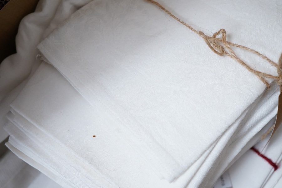 A collection of four sets of ten monogrammed French linen napkins and a similar set of twelve napkins, various odd sets of English Damask napkins, a large damask table cloth and a set of hand towels.